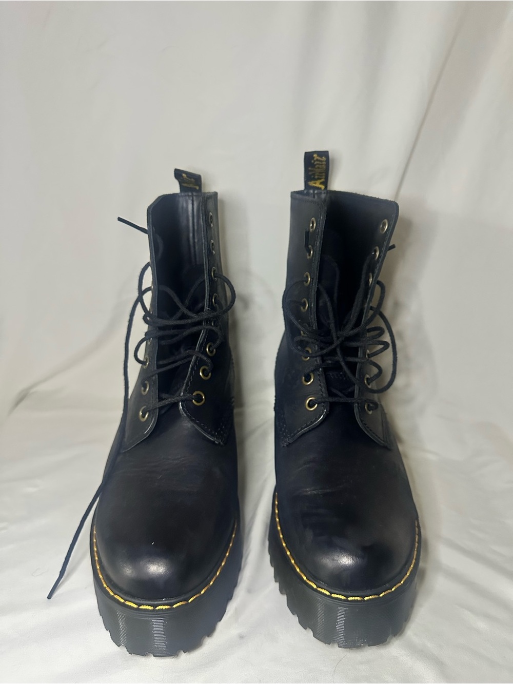 Like New Dr. Martens Black Lace-Up Boots with Yellow Stitching and a heel.